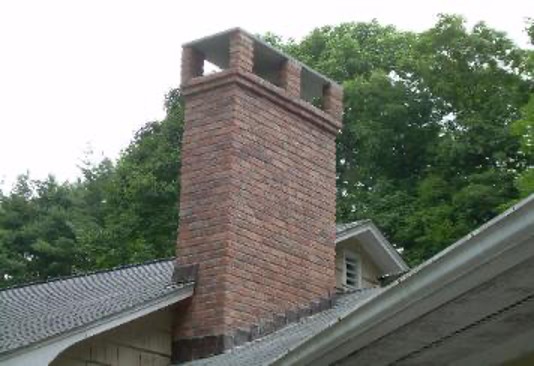 Brick chimney with a cap.
